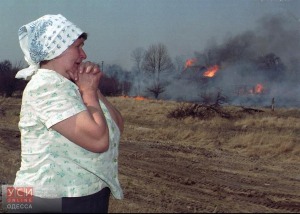 A Ukrainian watches as flames race through a field in Krasny Gorodok, a small village some 10 kilometers (6 miles) from the Chernobyl nuclear power plant. The fire raced through five villages for seven hours Tuesday April 23, 1996 sending an unknown amount of radioactive particles into the atmopshere, according to officals. (AP Photo)
