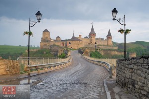 Road leading to the medieval castle. Fortification historical landmark. Cityscape at morning. Kamenetz-Podolsk, Ukraine, Europe